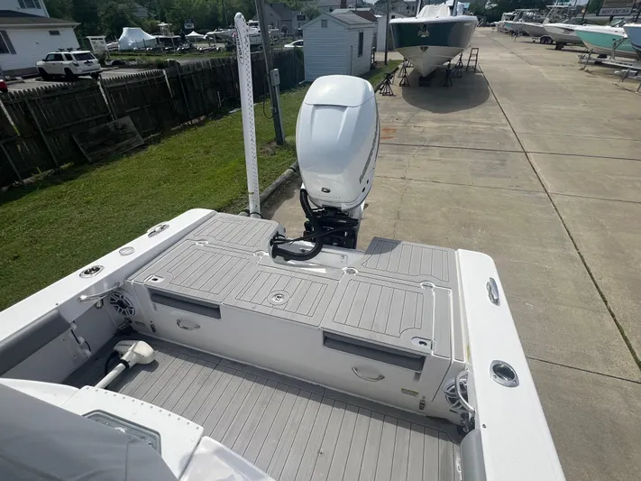  Yacht Photos Pics 2023 Everglades 253 CC boat with outboard motor, docked on a sunny day.