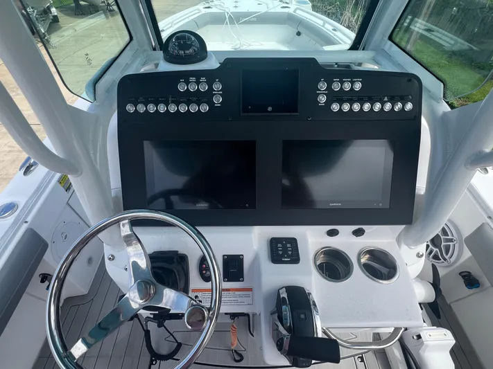  Yacht Photos Pics 2023 Everglades 253 CC boat dashboard with dual screens and steering wheel.