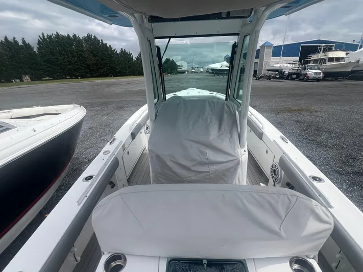  Yacht Photos Pics 2023 Everglades 253 CC boat with covered console, docked outdoors.