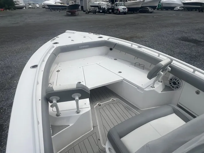  Yacht Photos Pics 2023 Everglades 253 CC boat interior with seating and steering wheel, docked in a marina.