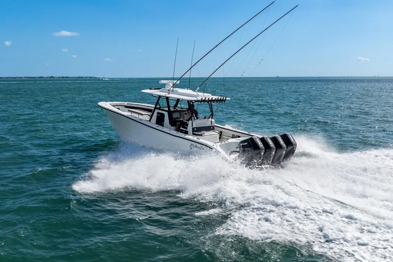  Yacht Photos Pics 2024 Yellowfin 39 Offshore boat cruising on open water with fishing rods.