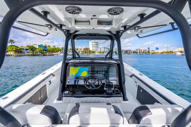  Yacht Photos Pics 2024 Yellowfin 39 Offshore boat interior with advanced navigation system on a sunny day.