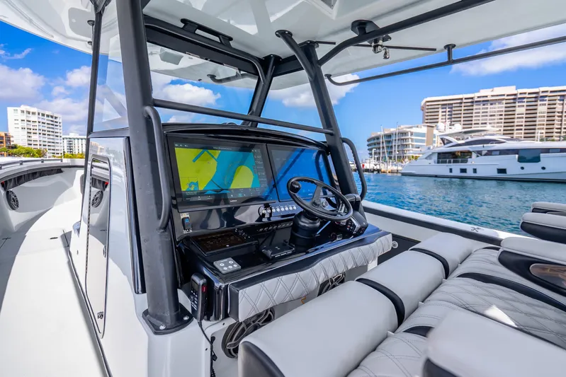  Yacht Photos Pics 2024 Yellowfin 39 Offshore boat interior with advanced navigation system, docked in a marina.