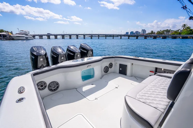 Yacht Photos Pics 2024 Yellowfin 39 Offshore boat with four Mercury engines, docked near a bridge.