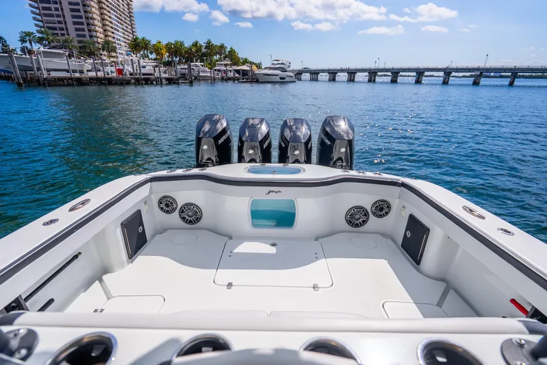  Yacht Photos Pics 2024 Yellowfin 39 Offshore boat with quad engines, docked near a marina under a sunny sky.