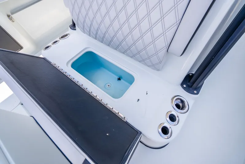  Yacht Photos Pics 2024 Yellowfin 39 Offshore boat interior with open storage compartment and rod holders.