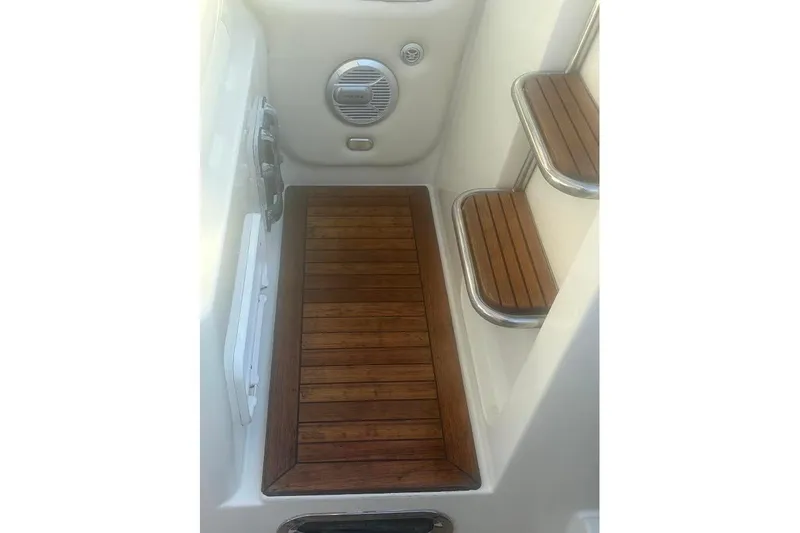 Andiamo Yacht Photos Pics 2006 Chris-Craft Corsair 33 boat interior with wooden steps and flooring.