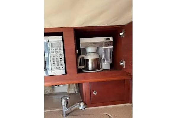 Andiamo Yacht Photos Pics 2006 Chris Craft Corsair Heritage kitchen with microwave, coffee maker, and wooden cabinetry.