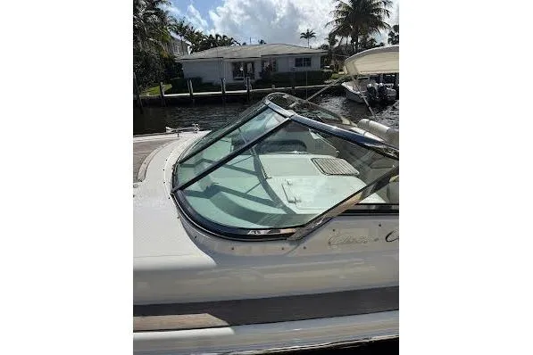 Andiamo Yacht Photos Pics 2006 Chris Craft Corsair Heritage boat docked near waterfront home.