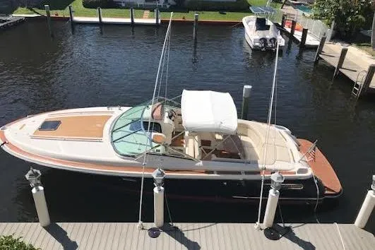 Andiamo Yacht Photos Pics 2006 Chris Craft Corsair Heritage boat docked in a marina, aerial view.