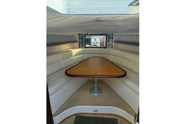 Andiamo Yacht Photos Pics Interior of 2006 Chris Craft Corsair Heritage boat with elegant seating and wooden table.