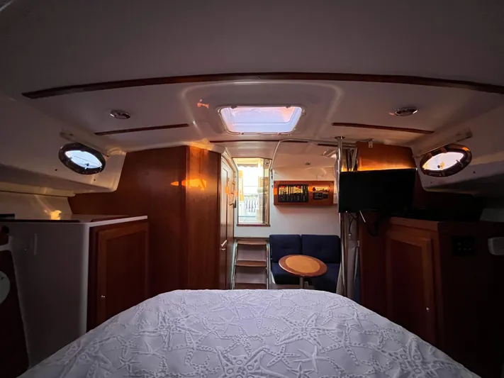  Yacht Photos Pics Interior of 2013 Back Cove 34 boat, featuring cozy cabin with bed and seating area.