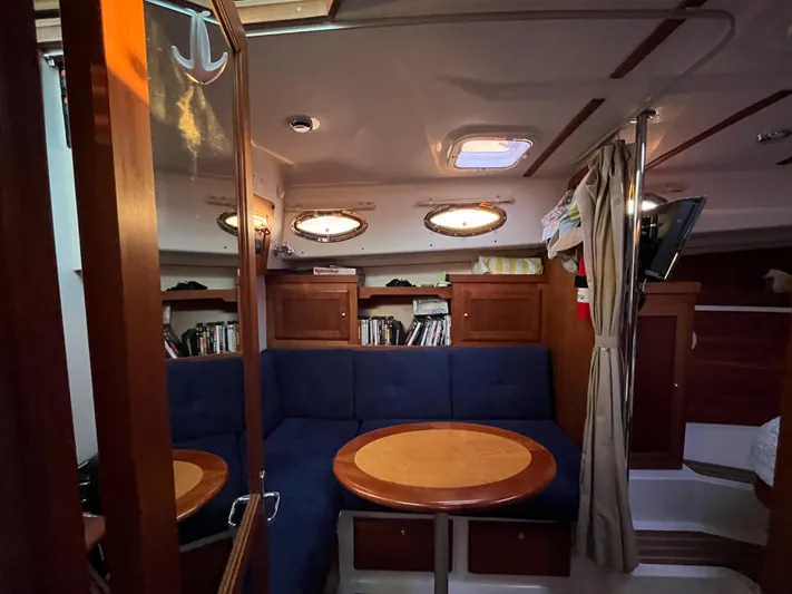  Yacht Photos Pics Interior of 2013 Back Cove 34 boat with cozy seating and wooden table.