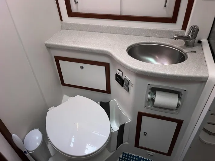  Yacht Photos Pics 2013 Back Cove 34 yacht bathroom with sink, toilet, and storage cabinets.