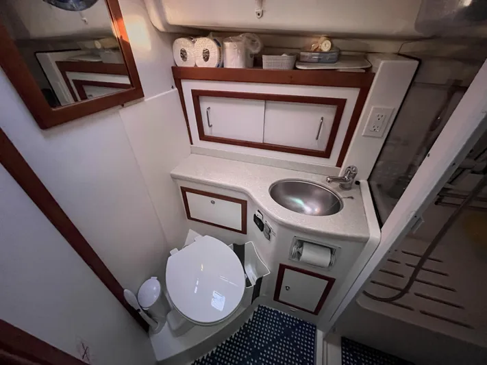  Yacht Photos Pics 2013 Back Cove 34 yacht bathroom with sink, toilet, and storage cabinets.