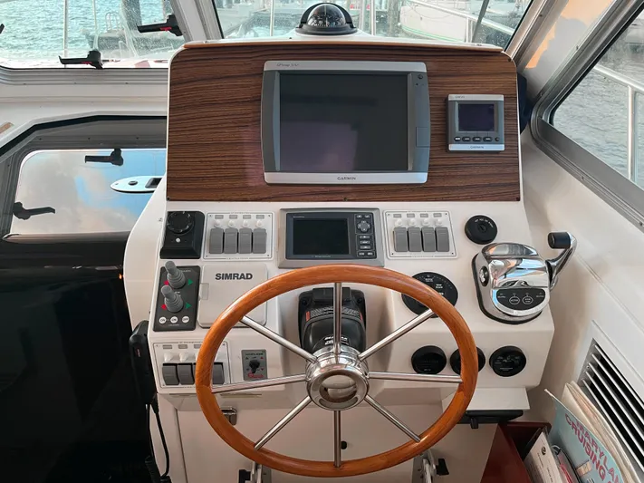  Yacht Photos Pics 2013 Back Cove 34 helm with wood accents and navigation equipment.