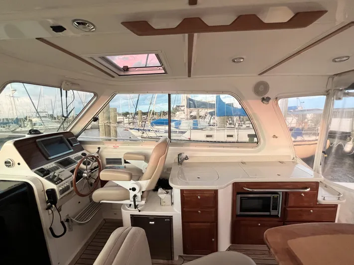  Yacht Photos Pics Interior of 2013 Back Cove 34 yacht with helm, seating, and kitchenette.