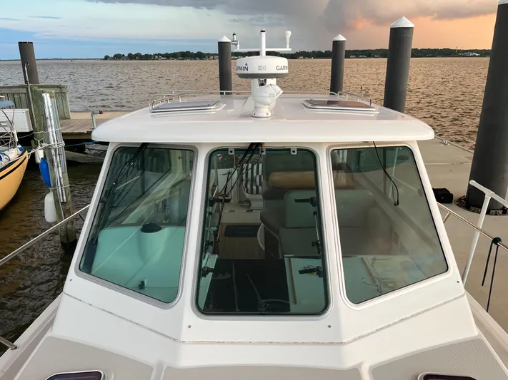  Yacht Photos Pics 2013 Back Cove 34 boat docked at marina with scenic water view.