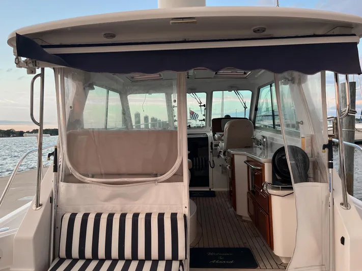  Yacht Photos Pics 2013 Back Cove 34 boat interior with striped seating and clear canopy.