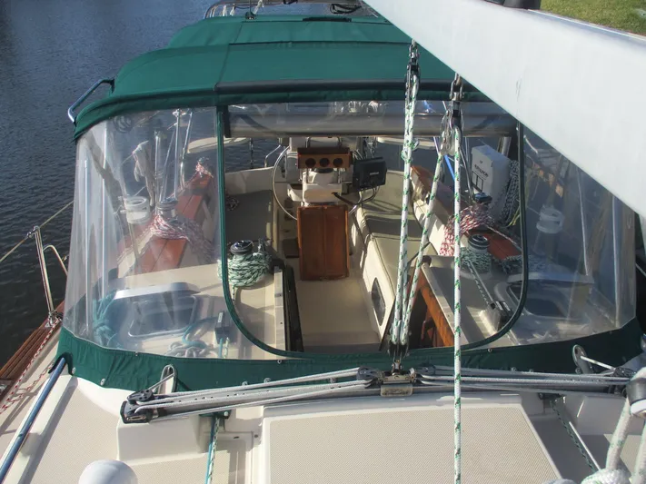  Yacht Photos Pics 1999 Island Packet 380 sailboat cockpit with green canopy and clear panels.