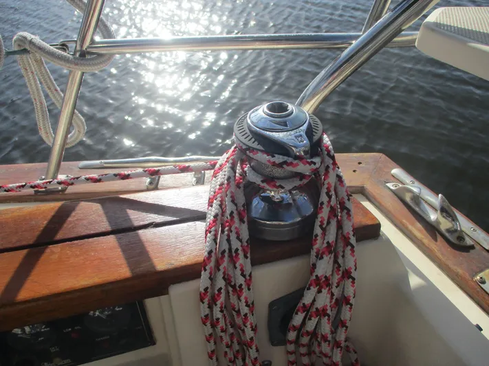  Yacht Photos Pics Sailboat winch with ropes on 1999 Island Packet 380, reflecting sunlight on water.