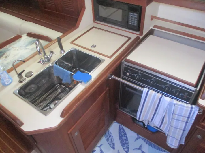  Yacht Photos Pics 1999 Island Packet 380 yacht kitchen with sink, stove, and microwave.