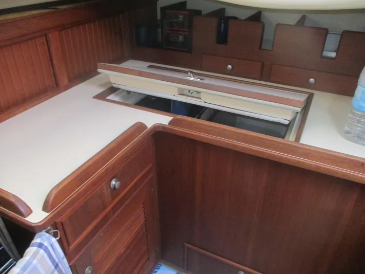  Yacht Photos Pics Interior of 1999 Island Packet 380 sailboat with wooden cabinetry and countertop.