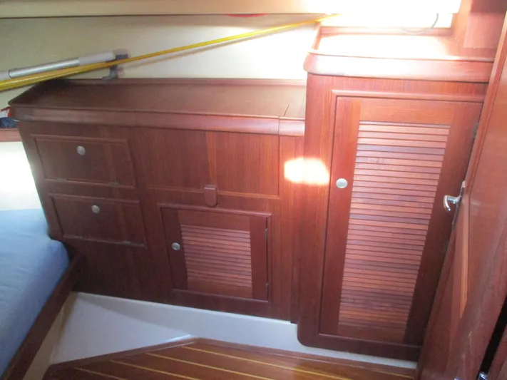  Yacht Photos Pics Interior of 1999 Island Packet 380 sailboat with wooden cabinetry and storage compartments.