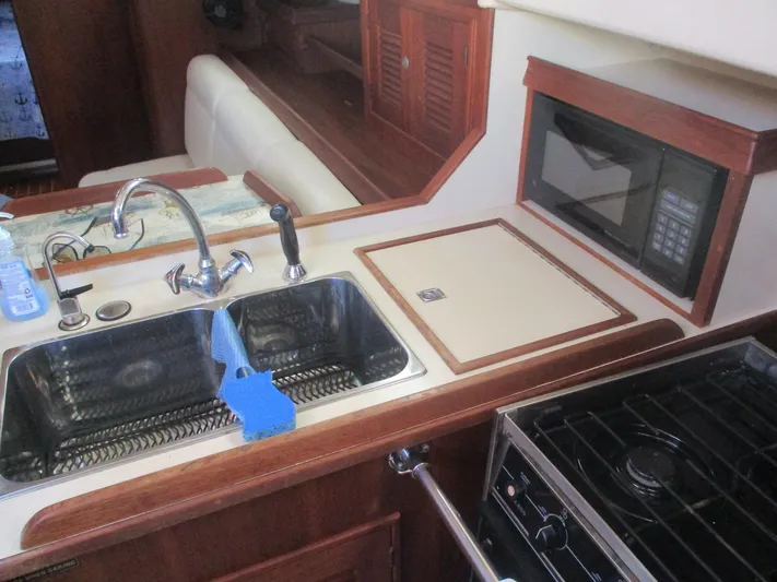  Yacht Photos Pics Island Packet 380 yacht kitchen with sink, stove, and microwave, 1999 model.