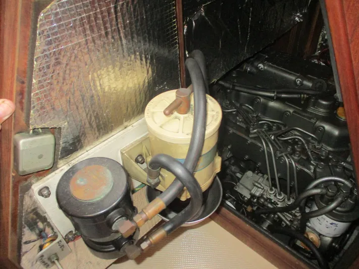  Yacht Photos Pics Engine compartment of a 1999 Island Packet 380 sailboat, showing fuel filter and engine components.