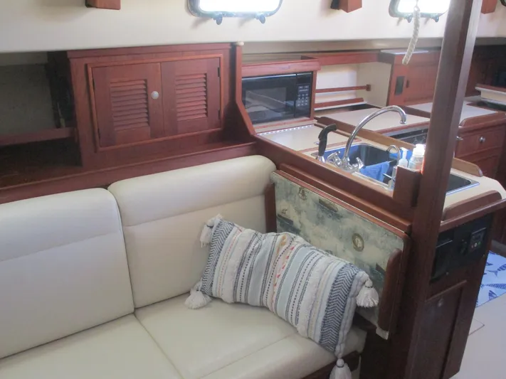  Yacht Photos Pics Interior of 1999 Island Packet 380 yacht with cozy seating and kitchen area.
