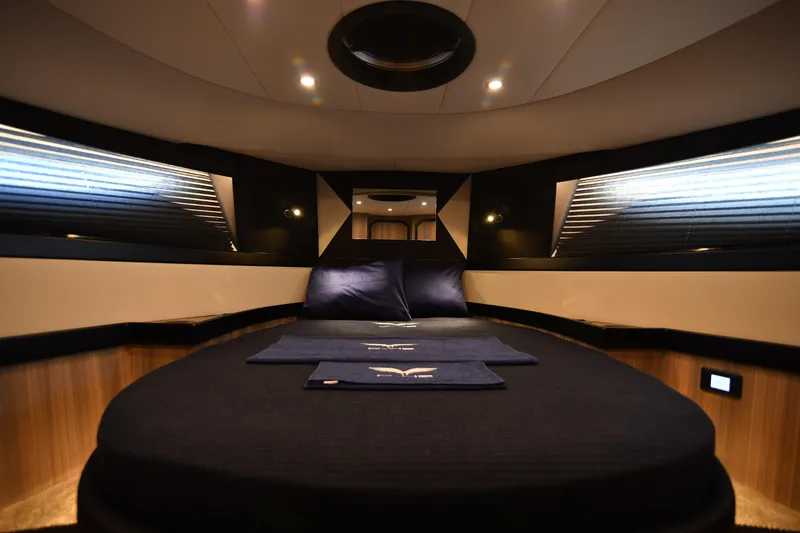 Falcon F-42 2x440 Hp Yanmar Yacht Photos Pics Luxurious cabin interior of 2025 Falcon Yachts F-42, featuring elegant bedding and ambient lighting.