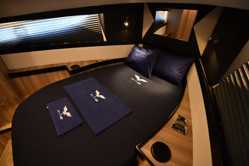 Falcon F-42 2x440 Hp Yanmar Yacht Photos Pics Luxurious cabin interior of 2025 Falcon Yachts F-42, featuring elegant bedding and modern design.