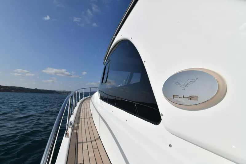 Falcon F-42 2x440 Hp Yanmar Yacht Photos Pics 2025 Falcon Yachts F-42, sleek design, cruising on open water under clear skies.