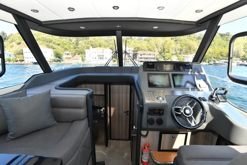 Falcon F-42 2x440 Hp Yanmar Yacht Photos Pics Luxurious Falcon Yachts F-42 cockpit with modern controls, 2025 model, scenic waterfront view.