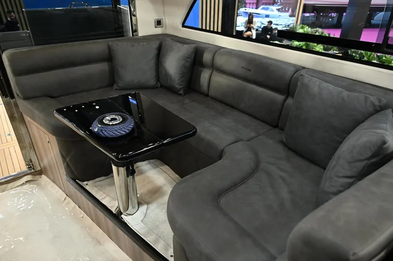 Falcon F-42 2x440 Hp Yanmar Yacht Photos Pics Luxurious interior of 2025 Falcon Yachts F-42 with plush seating and sleek black table.