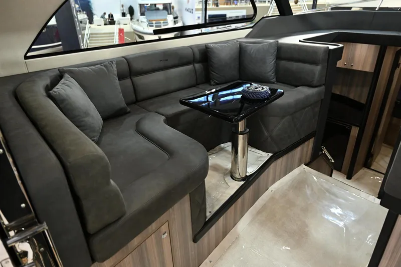Falcon F-42 2x440 Hp Yanmar Yacht Photos Pics Luxurious interior of 2025 Falcon Yachts F-42 with plush seating and sleek table.