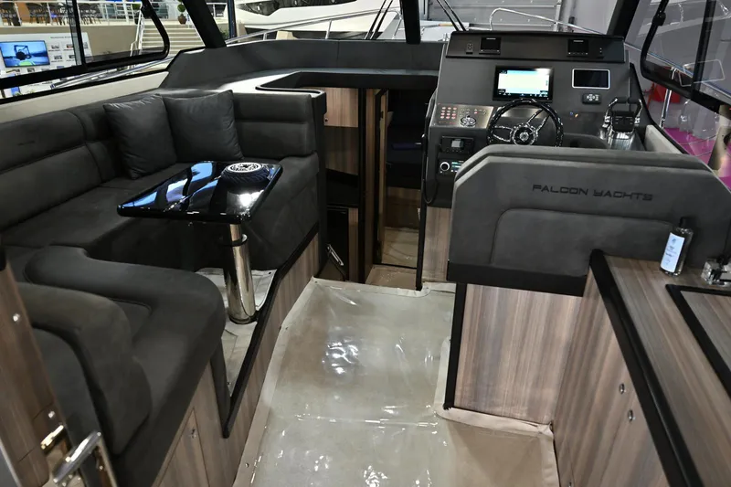 Falcon F-42 2x440 Hp Yanmar Yacht Photos Pics Luxurious interior of 2025 Falcon Yachts F-42 with joystick control and plush seating.