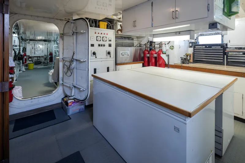  Yacht Photos Pics Engine room of a 1974 Willard 1201 vessel with control panels and workbench.