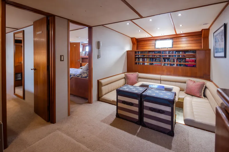  Yacht Photos Pics Luxurious interior of 1974 Willard 1201 yacht with cozy seating and bookshelf.