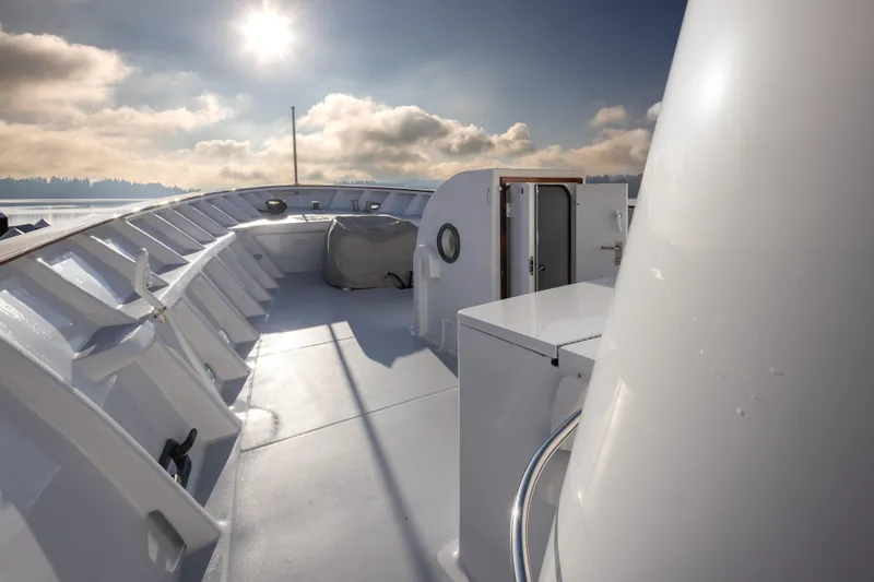  Yacht Photos Pics 1974 Willard 1201 boat deck under sunny sky, featuring sleek white design.