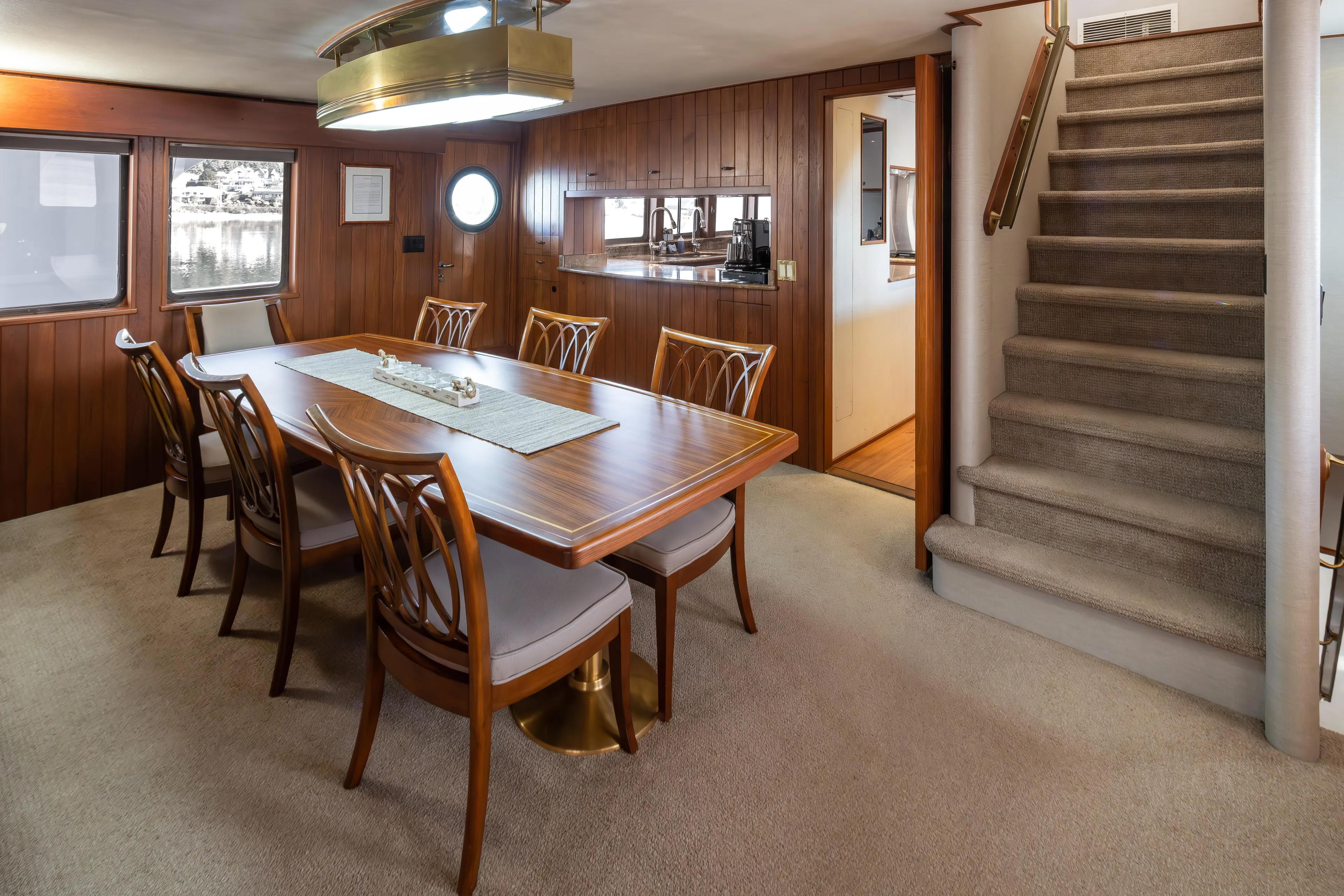  Yacht Photos Pics Luxurious dining area on a 1974 Willard 1201 yacht with elegant wood paneling.