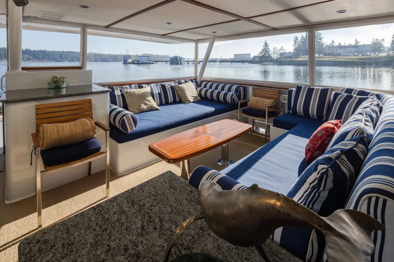  Yacht Photos Pics Luxurious interior of 1974 Willard 1201 yacht with striped seating and scenic water view.