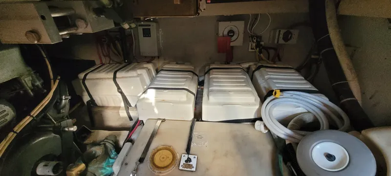 Midnight Yacht Photos Pics Engine room of 2001 Sabreline 43 Flybridge Motoryacht, featuring batteries and mechanical components.