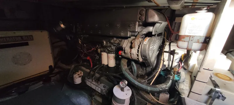 Midnight Yacht Photos Pics Engine room of 2001 Sabreline 43 Flybridge Motoryacht, showcasing mechanical components and generator.