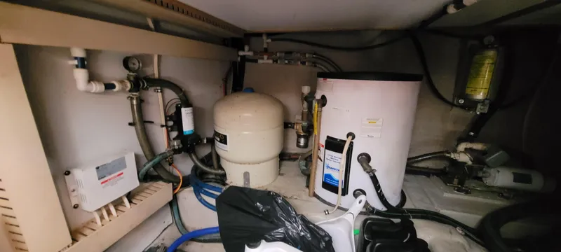 Midnight Yacht Photos Pics Engine room of 2001 Sabreline 43 Flybridge Motoryacht, featuring water heater and plumbing components.