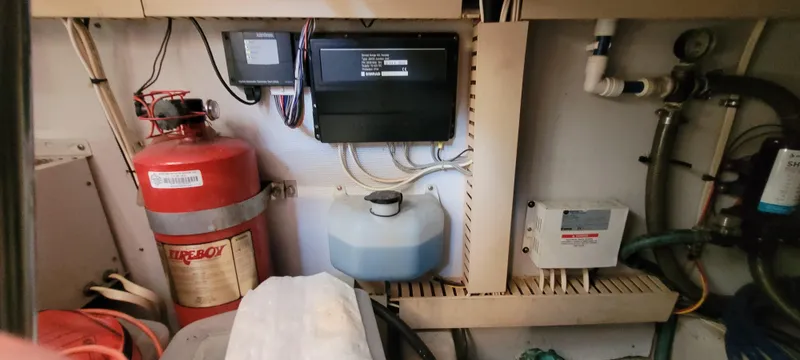 Midnight Yacht Photos Pics Engine room of 2001 Sabreline 43 Flybridge Motoryacht with fire extinguisher and control panels.