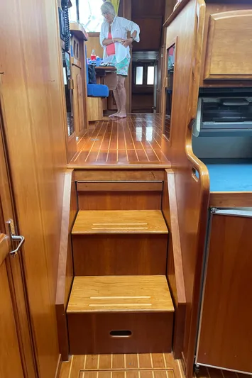 Midnight Yacht Photos Pics Interior of 2001 Sabreline 43 Flybridge Motoryacht, featuring wooden stairs and a person in the background.