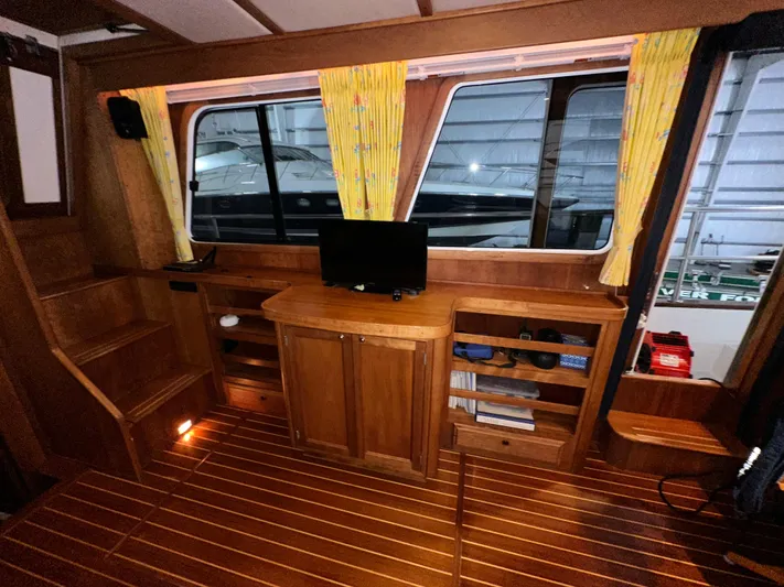 Midnight Yacht Photos Pics Interior of 2001 Sabreline 43 Flybridge Motoryacht with wooden cabinetry and small TV.