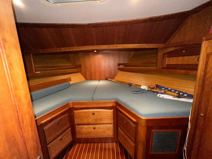Midnight Yacht Photos Pics Luxurious cabin interior of 2001 Sabreline 43 Flybridge Motoryacht, featuring wood finish and cozy bedding.
